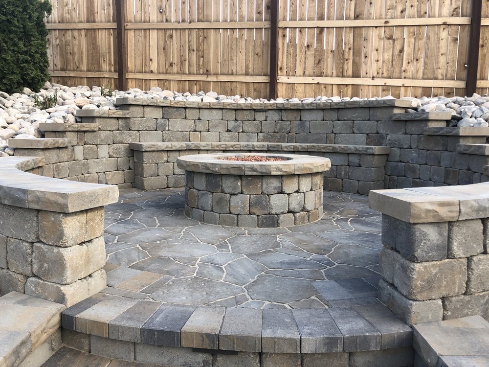 brick fire pit with seating and retaining wall